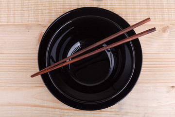 Chopsticks in asian set table on wood background
