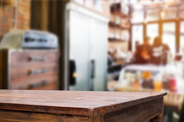 Selected focus empty brown wooden table and Coffee shop blur bac