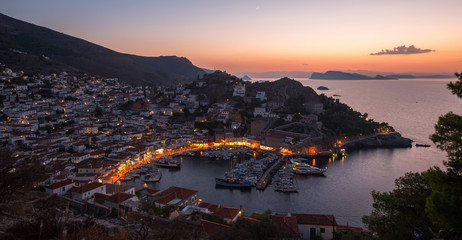 Top view twilight of Hydra island, Greece - city center and yaht marina after sunset.