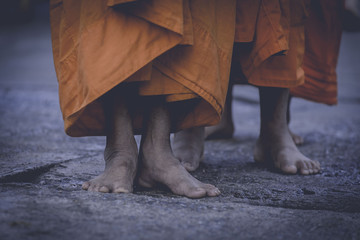 Feet of a Buddhist monk in the morning walk.Tone style film