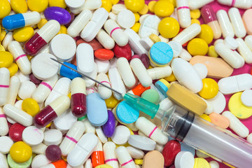 Variety of colorful medication and on syring. Top View, Closeup.