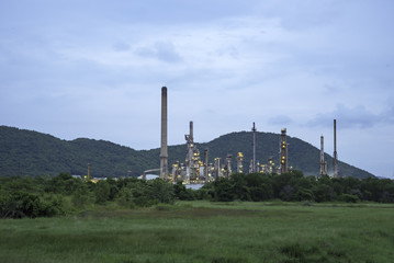 Fototapeta na wymiar Oil refinery plant at sunrise with sky background