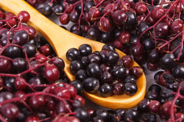 Heap of elderberry with wooden spoon, healthy food