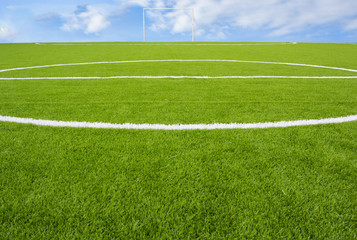 Obraz premium Artificial turf football field green on sky background