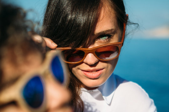 Brunet girl looking over sunglasses