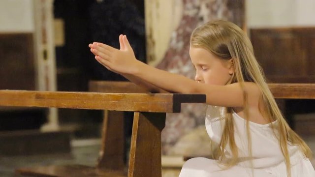 Little girl praing in the church