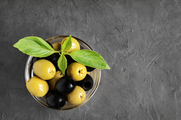 Black and green olives in glass bowl