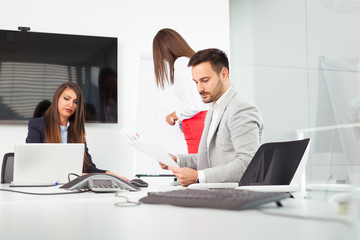 Business people in office holding a conference and discussing strategies