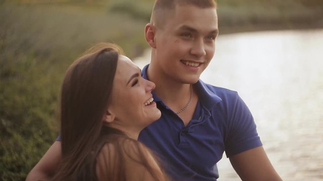 Romantic date. Couple in love on the shore near the water