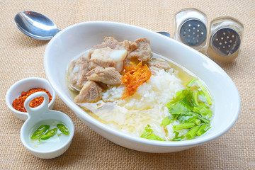 boiled rice with pork rib hot soup on bowl
