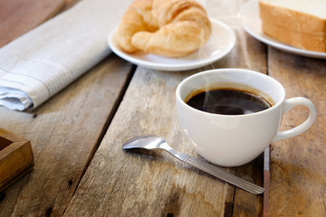 breakfast with croissants, cup of coffee.