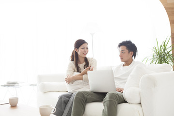 Young couple are talking happily in the living room