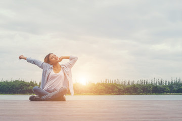 young beautiful hipster woman sitting on lake holiday relaxing e