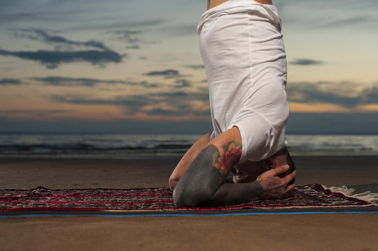 Yoga Man Doing Headstand Pose On The Beach