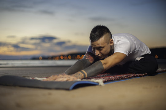 Young Flexible Man Practicing Yoga Outdoors