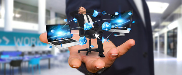 Man on his chair at the office connected to modern devices