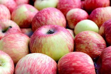 Many red apples floating in the water.