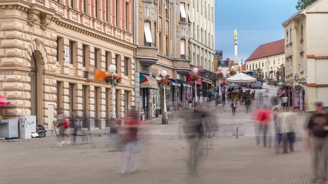Street with historic buildings in citycentre and Holy Mary monument in front of the Cathedral timelapse in Zagreb, Croatia