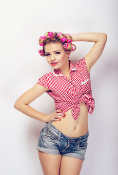 A girl dressed in pin-up style posing in studio