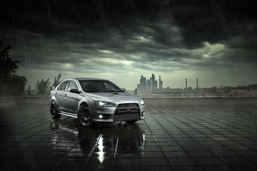 Obraz premium Gray car stay and reflect in wet road in heavy rain at daytime