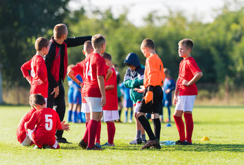 Obraz premium Boys playing football soccer game on sports field