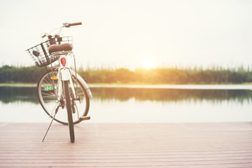 Vintage toned of bicycle with basket on empty pier, summer day.