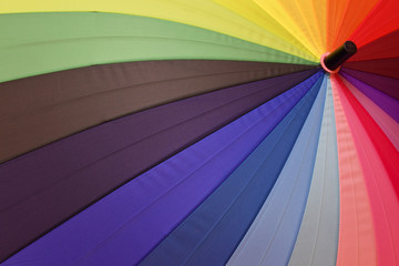 Bright umbrella with rainbow colors closeup