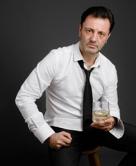 Sad mature man drinking alcohol