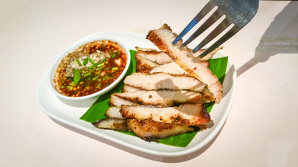Grilled sliced Pork BBQ Savory and spicy sauce . Adjust the image darker tone