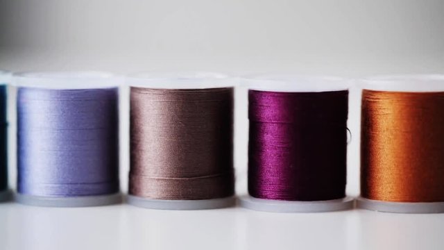 row of colorful thread spools on table