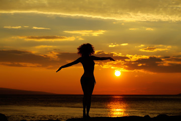 woman silhouette in sunset beach