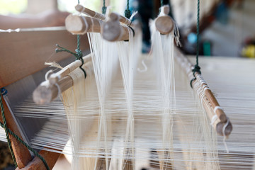 Close up loom with white yarn