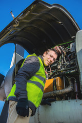 Naklejka premium Mechanic near airplanes engine