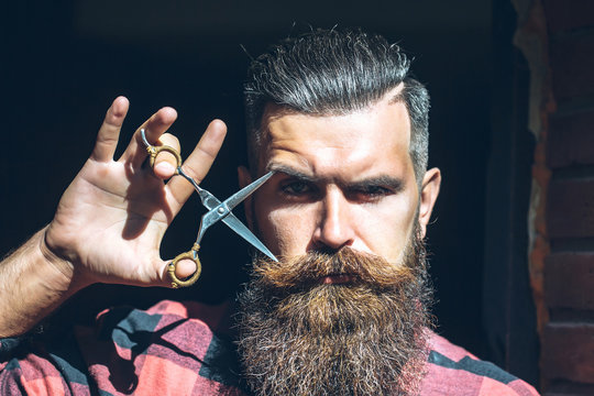 Man hipster with scissors