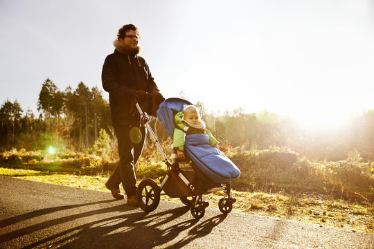 Father and son in buggy on a walk in forest