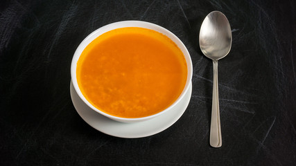Cream of pumpkin soup with spoon