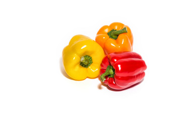 Red, orange and yellow pepper isolated on white