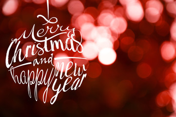 Christmas and happy new year lettering calligraphic text with red blur light bokeh background