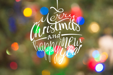 Naklejka premium Christmas and happy new year lettering calligraphic text with colorful blur light bokeh background
