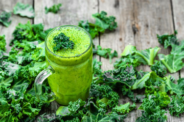 Healthy smoothie with green leaves of kale in jar 