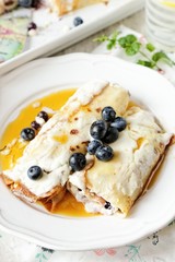 Baked crepes with cheese maple syrup and blueberries