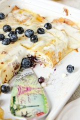 Baked crepes with cheese maple syrup and blueberries