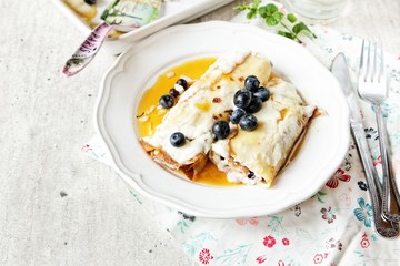 Baked crepes with cheese maple syrup and blueberries