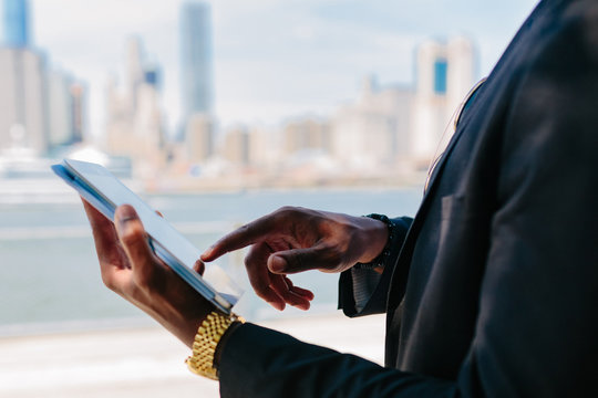 Young Black Businessman Using a Digital Tablet . Manhattan Background New York City
