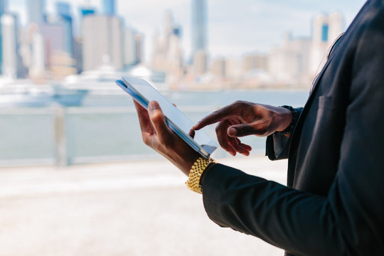 Young Black Businessman Using a Digital Tablet . Manhattan Background New York City