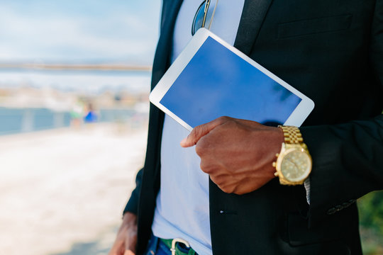 Young Black Businessman Heading to Work Holding a Digital Tablet . New York City