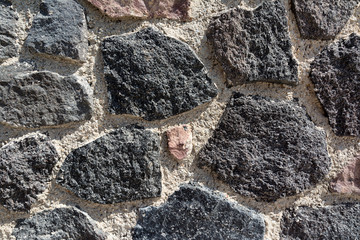 Closeup of volcanic stone wall in Santorini, Greece