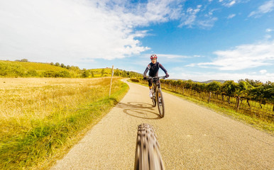 Pair of Man on mountain bike in a countryside. View from back of bicycle. Original point of view