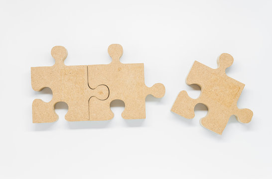 Three pieces of wooden puzzle on white background and selective focus