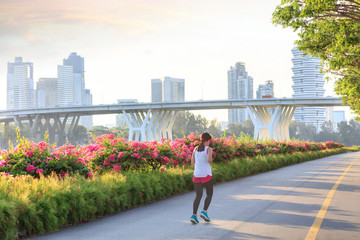 Jogger at Marina Bay East park at sunset